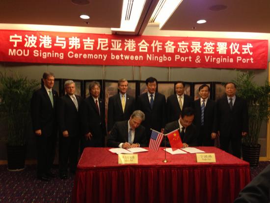 The VPA's Russell J. Held (left) and Port of Ningbo's Chang Boaping signed the memorandum of understanding this week. Virginia Gov. Bob McDonnell (standing row, fourth from left) helped facilitate the agreement.